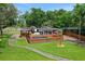 Aerial view of the house showing the pool, deck, gazebo, and landscaped yard at 1700 Lake Markham Rd, Sanford, FL 32771