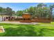 Spacious backyard with lush lawn, a large deck, and a gazebo for outdoor enjoyment at 1700 Lake Markham Rd, Sanford, FL 32771
