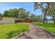 Landscaped backyard features a charming gazebo and a walkway to the lake at 1700 Lake Markham Rd, Sanford, FL 32771
