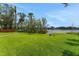 Expansive green backyard with lush lawn and scenic water view, perfect for outdoor activities at 1700 Lake Markham Rd, Sanford, FL 32771