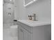 Stylish bathroom featuring a vanity, toilet, and walk-in shower with marble-style tile at 1700 Lake Markham Rd, Sanford, FL 32771