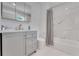 Modern bathroom featuring a sleek vanity, marble accents, and a shower/tub combination at 1700 Lake Markham Rd, Sanford, FL 32771