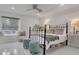 Bright bedroom featuring a metal bed frame, stylish seating, and modern lighting at 1700 Lake Markham Rd, Sanford, FL 32771