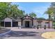 Front exterior view highlighting the home's covered entry, black garage doors, and professional landscaping at 1700 Lake Markham Rd, Sanford, FL 32771