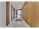 Hallway with vertical wood paneling, white tile flooring, and stylish decor at 1700 Lake Markham Rd, Sanford, FL 32771