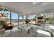 Bright living room features sliding glass doors with views of the pool and deck area by the lake at 1700 Lake Markham Rd, Sanford, FL 32771