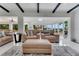 Open-concept living room with stylish furnishings, seamlessly connected to the dining area and outdoor views at 1700 Lake Markham Rd, Sanford, FL 32771
