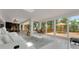 Bright living room featuring sliding glass doors to a deck and white tile flooring at 1700 Lake Markham Rd, Sanford, FL 32771