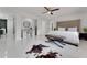 Bright main bedroom boasts white tile floors, a vanity, and an upholstered headboard at 1700 Lake Markham Rd, Sanford, FL 32771