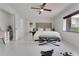 White main bedroom offers a closet, an upholstered headboard, and a ceiling fan at 1700 Lake Markham Rd, Sanford, FL 32771