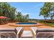 Inviting pool area on a wooden deck overlooking scenic water, perfect for relaxation and outdoor enjoyment at 1700 Lake Markham Rd, Sanford, FL 32771