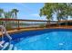 Inviting in-ground pool surrounded by a wooden deck and a beautiful outdoor view at 1700 Lake Markham Rd, Sanford, FL 32771