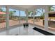 Inviting sun room with glass doors showcasing the pool and outdoor entertainment space and lake views at 1700 Lake Markham Rd, Sanford, FL 32771
