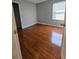 Cozy bedroom featuring wood floors, neutral paint, and a bright window at 1754 Fritwell Ct, Ocoee, FL 34761
