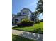 Charming two-story home with well-maintained lawn and manicured shrubbery at 1754 Fritwell Ct, Ocoee, FL 34761