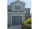 Two-story home showing garage, updated landscaping, and modern paint scheme at 1754 Fritwell Ct, Ocoee, FL 34761