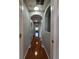 Hallway with arched openings and hardwood floors at 1754 Fritwell Ct, Ocoee, FL 34761