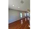 Open concept living room with hardwood flooring, natural light, and ceiling fan at 1754 Fritwell Ct, Ocoee, FL 34761