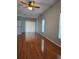 Open concept living room with hardwood flooring, natural light, and ceiling fan at 1754 Fritwell Ct, Ocoee, FL 34761