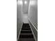 Carpeted stairway with neutral walls and a sleek white handrail at 1754 Fritwell Ct, Ocoee, FL 34761