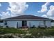 The rear exterior of the house shows the sliding door to access the backyard and the lawn swing at 1858 Snapper Dr, Poinciana, FL 34759