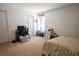 Bright bedroom with a light beige carpet and white walls is lit by a window with white blinds at 1858 Snapper Dr, Poinciana, FL 34759