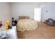 Cluttered bedroom featuring a bed, small table and a door to an adjoining room at 1858 Snapper Dr, Poinciana, FL 34759
