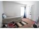A sparsely decorated bedroom with an exercise bike, single bed and a double closet at 1858 Snapper Dr, Poinciana, FL 34759