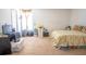 This bedroom is well-lit and shows a bed with a floral comforter, a window, and an entertainment center at 1858 Snapper Dr, Poinciana, FL 34759