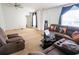 Cozy living room featuring a large sectional couch, neutral carpet, and ample space for entertaining and relaxing at 1858 Snapper Dr, Poinciana, FL 34759