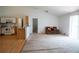 Spacious living room with carpet, a vaulted ceiling and an adjoining eat-in kitchen with laminate flooring at 1858 Snapper Dr, Poinciana, FL 34759