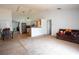 Open-concept living space with a combined eat-in kitchen, laminate flooring and access to the dining area at 1858 Snapper Dr, Poinciana, FL 34759