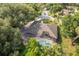 Aerial view of a home with a private screened pool and lush landscaping at 1947 Broadleaf Ct, Windermere, FL 34786