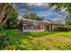 Spacious backyard with a pool and spa, screened enclosure and lush landscaping at 1947 Broadleaf Ct, Windermere, FL 34786