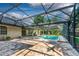Spacious brick paver patio with covered lanai, screened pool and lush backyard at 1947 Broadleaf Ct, Windermere, FL 34786