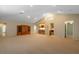 Spacious basement featuring carpet, a wet bar with stainless steel appliances, and custom cabinetry at 1947 Broadleaf Ct, Windermere, FL 34786