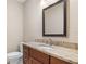 Bathroom featuring dark wood vanity, granite countertop and black framed mirror at 1947 Broadleaf Ct, Windermere, FL 34786