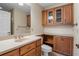 Bathroom featuring wood cabinetry, neutral counter tops and built-in storage at 1947 Broadleaf Ct, Windermere, FL 34786