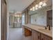 Spacious bathroom with dual sinks, vanity, and sliding glass door at 1947 Broadleaf Ct, Windermere, FL 34786