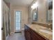 Bathroom featuring double vanity with granite countertop and a shower with decorative curtain at 1947 Broadleaf Ct, Windermere, FL 34786