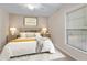Staged bedroom with warm decor, carpet, ceiling fan, and window at 1947 Broadleaf Ct, Windermere, FL 34786