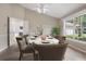 Dining room with large table, chairs, and a large window overlooking backyard at 1947 Broadleaf Ct, Windermere, FL 34786
