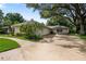 Spacious driveway and side view of a home with lush greenery and a two-car garage at 1947 Broadleaf Ct, Windermere, FL 34786