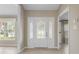 Bright foyer with tile flooring, decorative glass front door, and sidelight windows at 1947 Broadleaf Ct, Windermere, FL 34786
