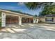 Spacious three-car garage featuring ample storage space and an expansive concrete driveway at 1947 Broadleaf Ct, Windermere, FL 34786