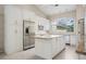 Bright kitchen features granite countertops, stainless appliances, tile floors and white cabinets at 1947 Broadleaf Ct, Windermere, FL 34786