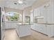 Bright kitchen features granite countertops, stainless appliances, tile floors and white cabinets at 1947 Broadleaf Ct, Windermere, FL 34786