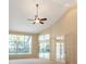 Bright living room with vaulted ceiling, expansive windows, and access to the outdoor space at 1947 Broadleaf Ct, Windermere, FL 34786