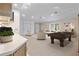 Spacious living room with neutral carpet, sitting area, and billiards table at 1947 Broadleaf Ct, Windermere, FL 34786