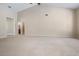 Spacious living room features vaulted ceilings, neutral carpet, and natural light from the window at 1947 Broadleaf Ct, Windermere, FL 34786